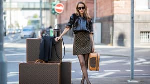 Frau mit Louis Vuitton Koffern und Taschen auf der Straße
