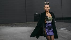 Frau trägt Paillettenkleid Streetstyle mit Mantel