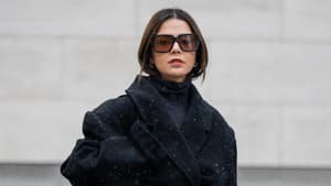 Amelie Stanescu trägt schwarzen Mantel Tasche und Sonnenbrille