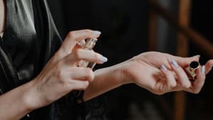 Frau trägt Parfum auf