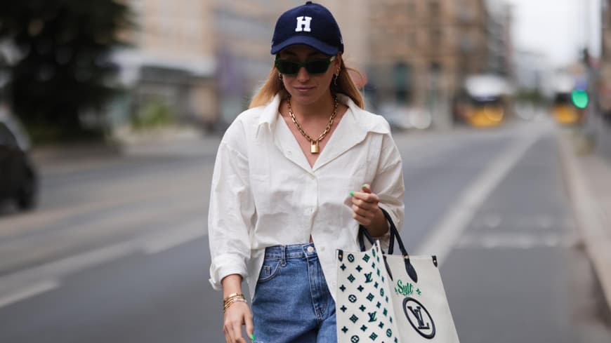Sonia Lyson trägt Jeansshorts Cap weiße Bluse
