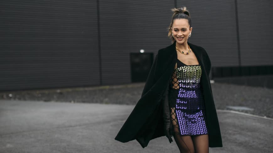 Frau trägt Paillettenkleid Streetstyle mit Mantel