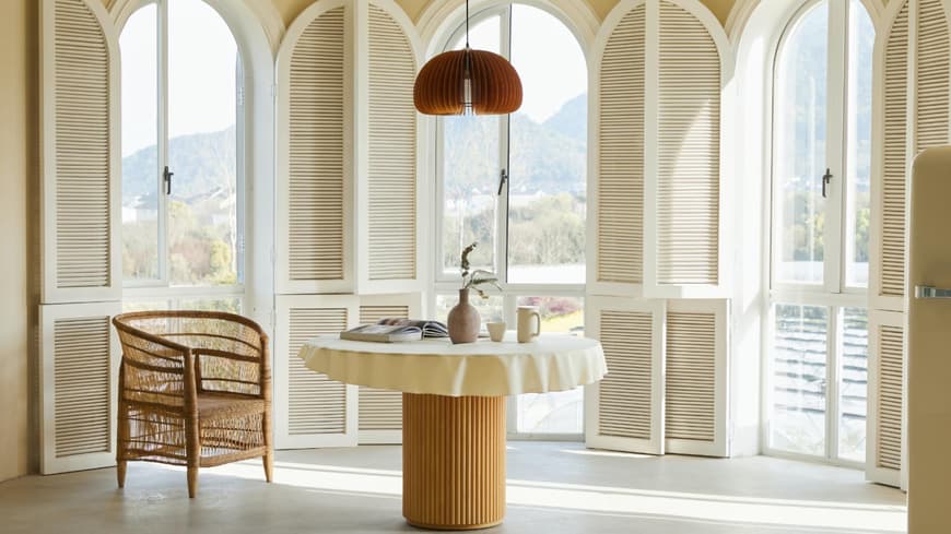 Mediterranes Zimmer mit rundem Tisch und Stuhl und Fenster Ausblick