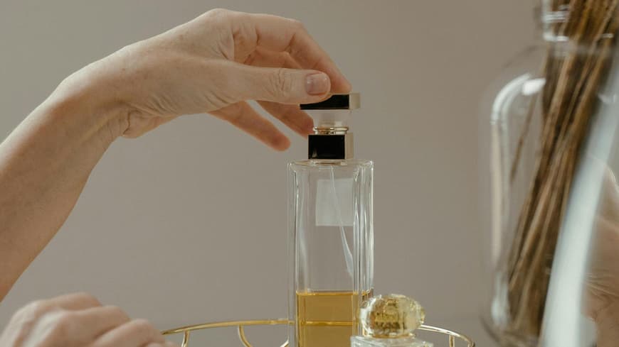 Frau greift zu einem Parfum