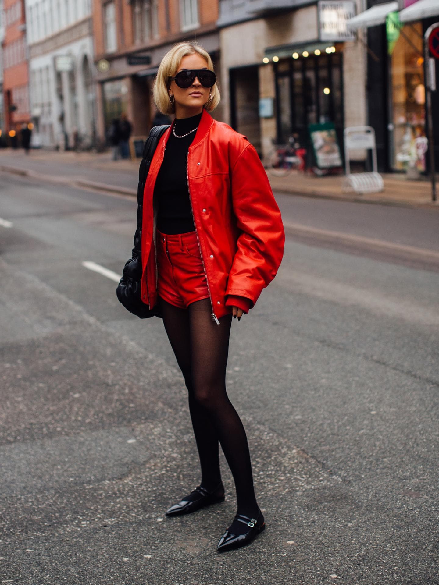 Frau mit roter Jacke und schwarzen Ballerinas