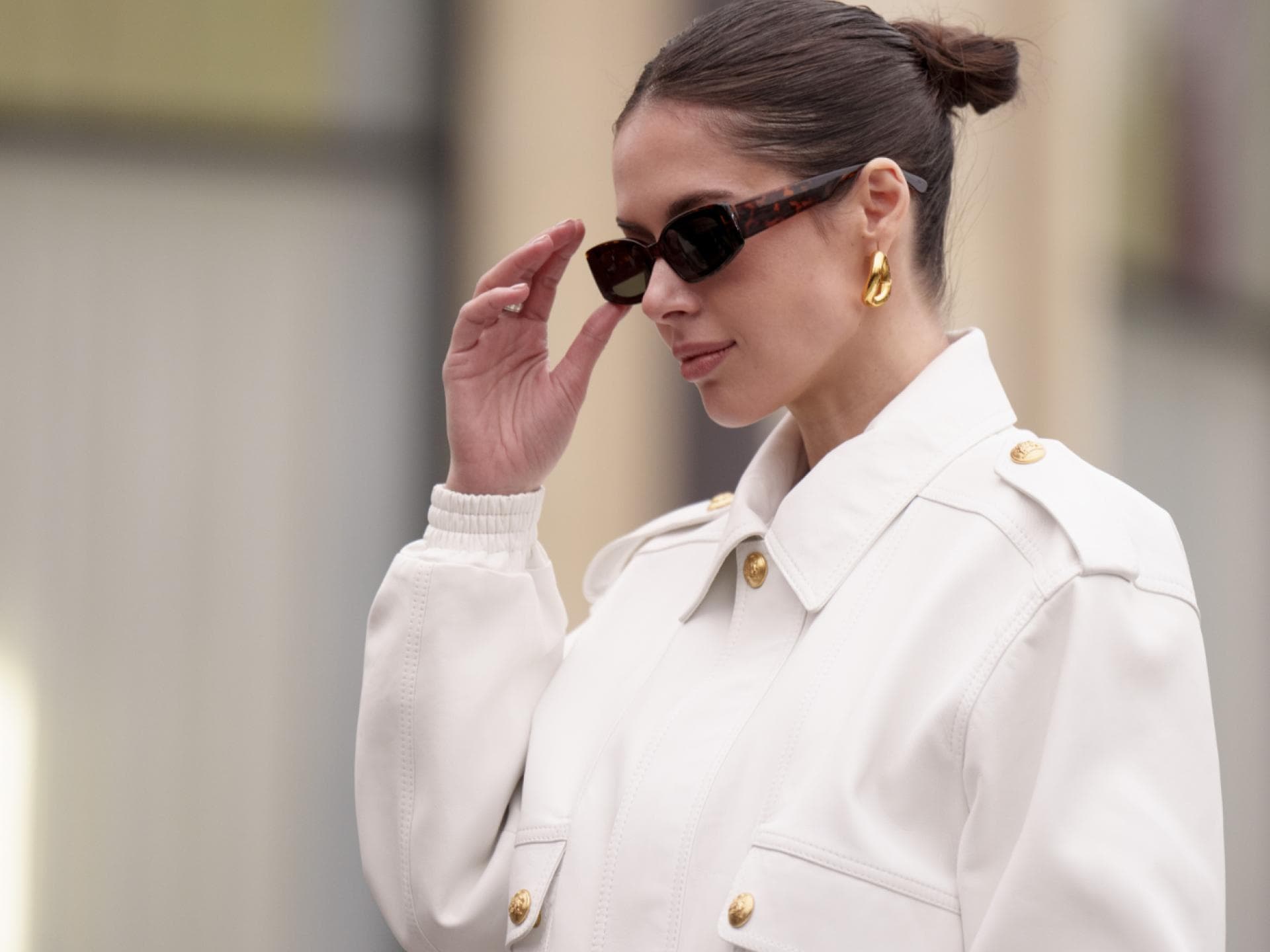 Paris Fashion Week Streetstyle Frau trägt weiße Jacke Sonnenbrille