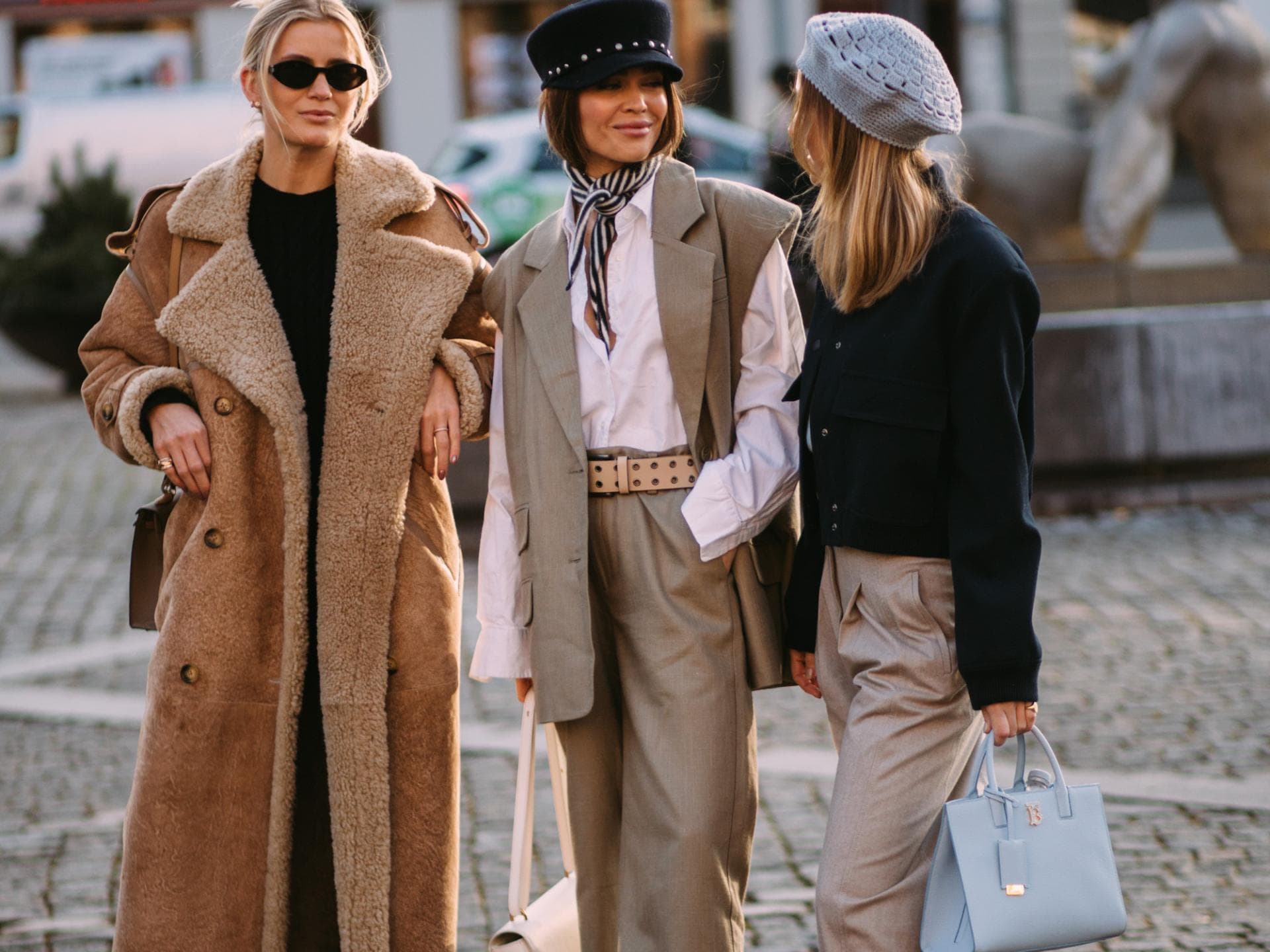 Drei stylische Frauen unterhalten sich auf der Fashion Week
