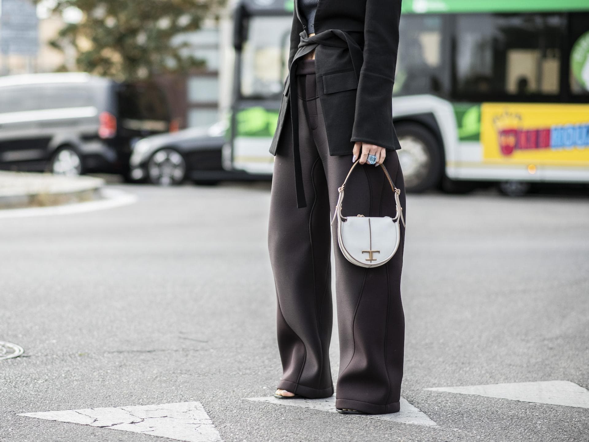 Frau mit Hosenanzug und weißer Tasche