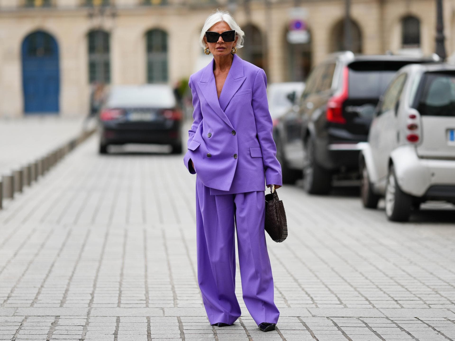 Frau mit violettem Hosenanzug und grauen Haaren