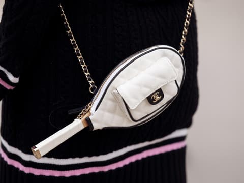 Frau mit Tasche in Tennisschlägerform
